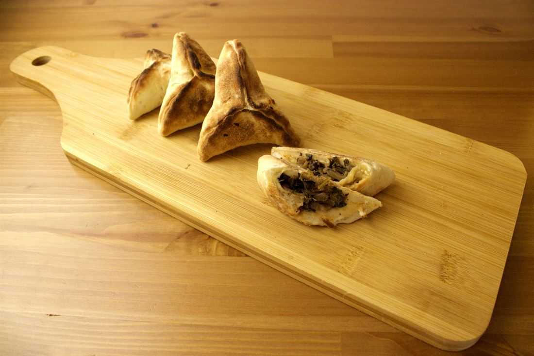 Mini spinach pies on a wooden board